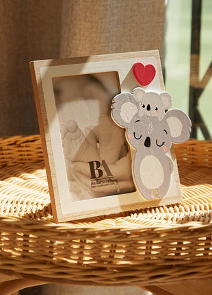 A charming wooden baby photo frame featuring an adorable koala design, perfect for displaying cherished baby photos. This whimsical frame is an ideal home decor piece for any nursery or living room, making it a thoughtful gift for new parents or families with babies. This baby photo frame makes a wonderful gift for baby showers or any special occasion, combining functionality and cute design to celebrate the arrival of a new baby. 6
