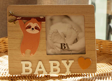 A charming wooden baby photo frame featuring an adorable sloth design, perfect for displaying cherished baby photos. This whimsical frame is an ideal home decor piece for any nursery or living room, making it a thoughtful gift for new parents or families with babies. With its cute sloth illustration and durable wooden construction, it adds a playful touch to any room while preserving precious memories. This baby photo frame makes a wonderful gift for baby showers or any special occasion, combining functiona