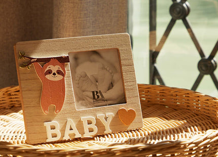 A charming wooden baby photo frame featuring an adorable sloth design, perfect for displaying cherished baby photos. This whimsical frame is an ideal home decor piece for any nursery or living room, making it a thoughtful gift for new parents or families with babies. With its cute sloth illustration and durable wooden construction, it adds a playful touch to any room while preserving precious memories. This baby photo frame makes a wonderful gift for baby showers or any special occasion, combining functiona