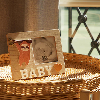 A charming wooden baby photo frame featuring an adorable sloth design, perfect for displaying cherished baby photos. This whimsical frame is an ideal home decor piece for any nursery or living room, making it a thoughtful gift for new parents or families with babies. With its cute sloth illustration and durable wooden construction, it adds a playful touch to any room while preserving precious memories. This baby photo frame makes a wonderful gift for baby showers or any special occasion, combining functiona