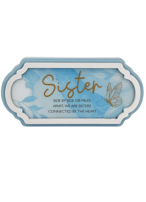 A beautifully designed blue decorative ornament, perfect for gifting to a sister. This home decor piece features a thoughtful design that symbolizes love and connection, making it an ideal gift for birthdays, holidays, or any special occasion. The elegant blue color and charming details make it a meaningful addition to any room, showcasing your affection and appreciation for your sister. This ornament serves as a heartfelt reminder of the bond shared with your sibling, bringing a touch of warmth and beauty 