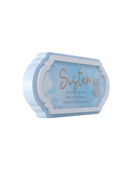 A beautifully designed blue decorative ornament, perfect for gifting to a sister. This home decor piece features a thoughtful design that symbolizes love and connection, making it an ideal gift for birthdays, holidays, or any special occasion. The elegant blue color and charming details make it a meaningful addition to any room, showcasing your affection and appreciation for your sister. This ornament serves as a heartfelt reminder of the bond shared with your sibling, bringing a touch of warmth and beauty 