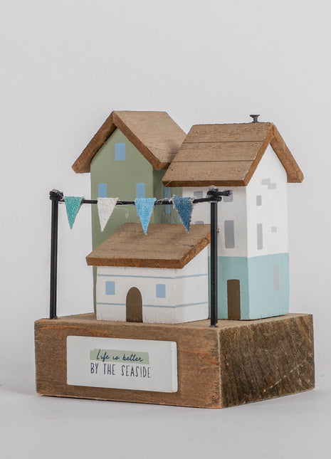 Charming coastal cottage miniature house decor in a beautiful seaside style, Life is Better by the Seaside, featuring a blue color scheme and intricate wooden design. This elegant home ornament adds a coastal vibe to any space, perfect for living rooms, offices, or as a gift for beach lovers. 1
