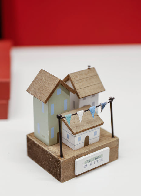Charming coastal cottage miniature house decor in a beautiful seaside style, Life is Better by the Seaside, featuring a blue color scheme and intricate wooden design. This elegant home ornament adds a coastal vibe to any space, perfect for living rooms, offices, or as a gift for beach lovers. 2
