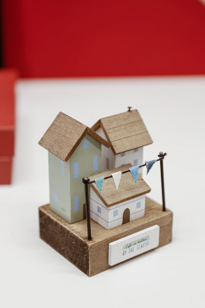 Charming coastal cottage miniature house decor in a beautiful seaside style, Life is Better by the Seaside, featuring a blue color scheme and intricate wooden design. This elegant home ornament adds a coastal vibe to any space, perfect for living rooms, offices, or as a gift for beach lovers. 2
