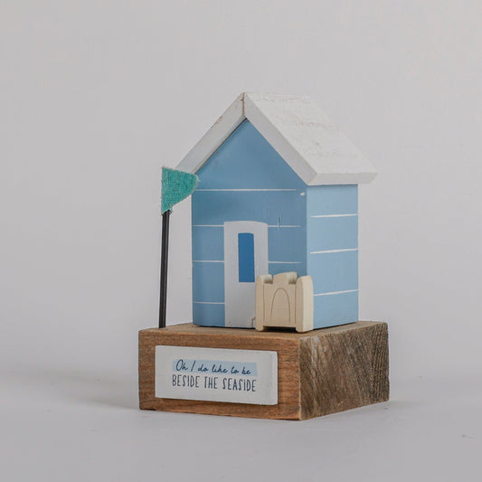 Charming coastal cottage miniature house decor in a beautiful seaside style,  Oh I Do Like to be Beside the Seaside, featuring a blue color scheme and intricate wooden design. This elegant home ornament adds a coastal vibe to any space, perfect for living rooms, offices, or as a gift for beach lovers. 1
