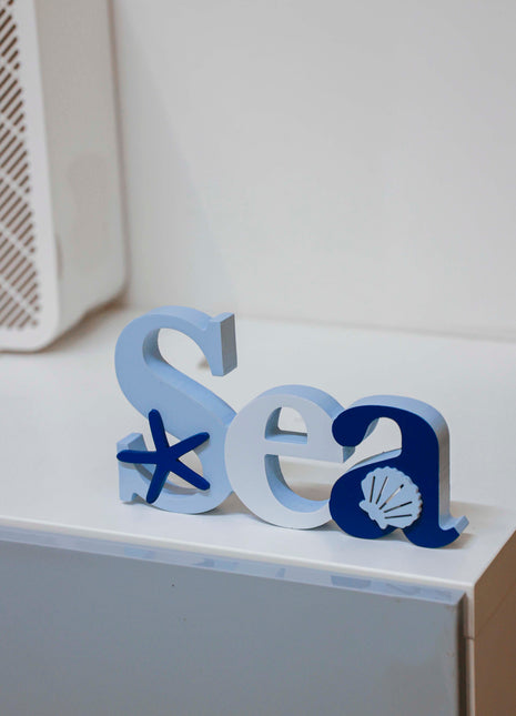 Charming coastal Sea letters shaped house decor with starfish and seashell in a beautiful seaside style, featuring a blue color scheme and intricate wooden design. This elegant home ornament adds a coastal vibe to any space, perfect for living rooms, offices, or as a gift for beach lovers. 2
