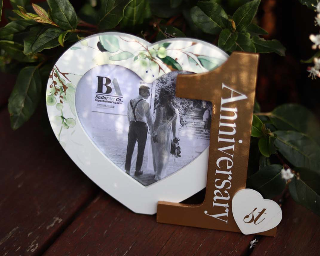 Heart-shaped photo frame featuring the word "Anniversary" and the number 1, a perfect romantic gift for couples celebrating their first anniversary, capturing cherished memories as a keepsake. 5
