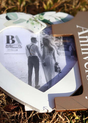 Heart-shaped photo frame featuring the word "Anniversary" and the number 1, a perfect romantic gift for couples celebrating their first anniversary, capturing cherished memories as a keepsake. 6

