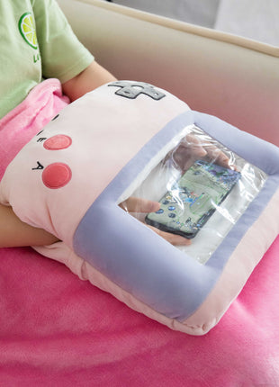 Adorable pink game console-shaped plush toy with a soft blanket inside and a hand-warmer feature in its belly. This multi-functional stuffed animal offers comfort and warmth, making it a perfect squishmallow-style throw pillow or plushie for cozy relaxation. 3
