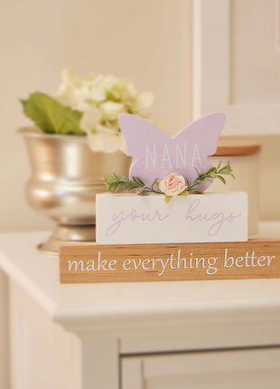 A beautifully designed purple butterfly-shaped ornament for grandma, adorned with vibrant floral details. This charming home decor piece is perfect for birthdays, holidays, or any special occasion. It serves as both a thoughtful gift and a delightful addition to grandma’s home. The elegant butterfly shape combined with delicate flowers makes it a meaningful token of love and appreciation, ideal for brightening her living space and reminding her of the special bond you share. A perfect choice to show your ca