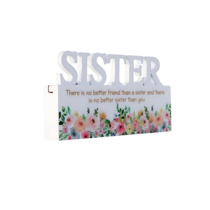 A charming white decorative ornament featuring the word "Sister" with beautiful floral patterns, making it an ideal home decor gift for your sister. The delicate floral design adds a touch of elegance and warmth, making it a perfect gift for birthdays, holidays, or any special occasion. This meaningful ornament symbolizes the love and connection shared between siblings and serves as a reminder of cherished moments. The simple yet elegant white color complements any home decor style, creating a heartfelt and