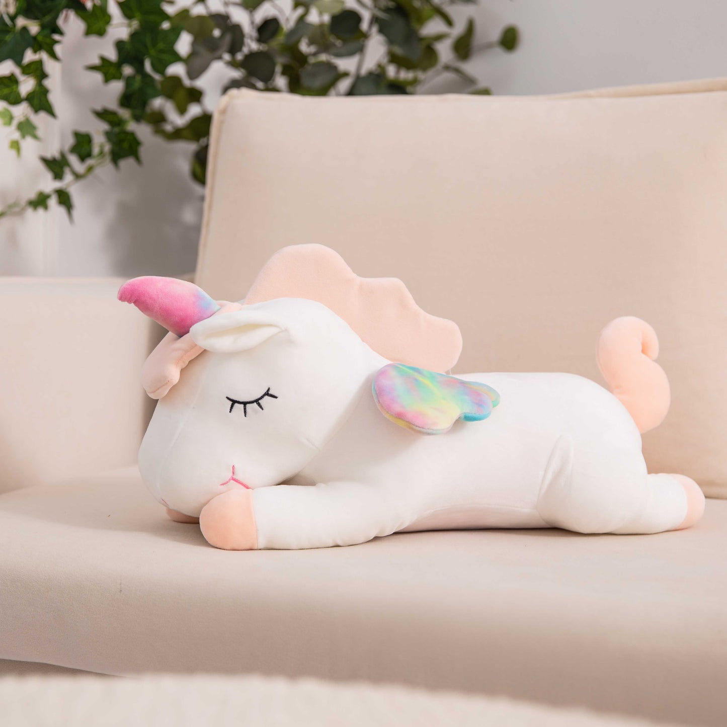 Adorable white unicorn plush toy with rainbow wings, featuring a cozy unicorn blanket tucked inside its belly. Soft and cuddly, this squishmallow-style stuffed animal doubles as a pillow for kids, making it the perfect plushie and comfort companion for bedtime or playtime. 3
