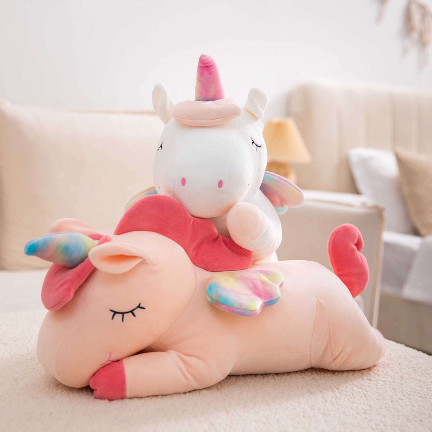 Adorable white unicorn plush toy with rainbow wings, featuring a cozy unicorn blanket tucked inside its belly. Soft and cuddly, this squishmallow-style stuffed animal doubles as a pillow for kids, making it the perfect plushie and comfort companion for bedtime or playtime. 4
