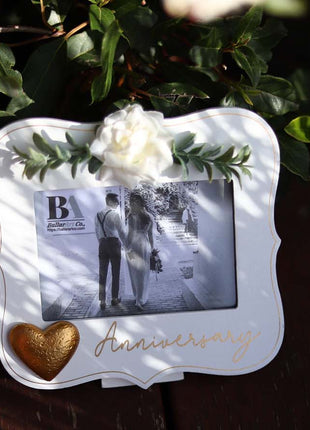  Elegant white wooden photo frame decorated with white flowers, hearts, and the word "Anniversary," making it a beautiful and thoughtful anniversary gift for couples, capturing special moments in a romantic keepsake. 3
