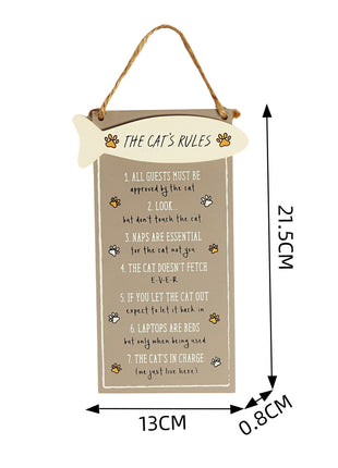 Charming wooden hanging sign featuring "The Cat's Rules" with a fish-shaped accent and adorable cat illustrations. Perfect wall or door decor for cat lovers, this brown wooden plaque adds a playful and decorative touch to any home space.