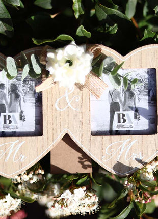 Wooden double photo frame featuring two interlocking hearts, each holding a photo, and adorned with a white flower. A perfect romantic gift for couples, weddings, or anniversaries, symbolizing love and togetherness. 2
