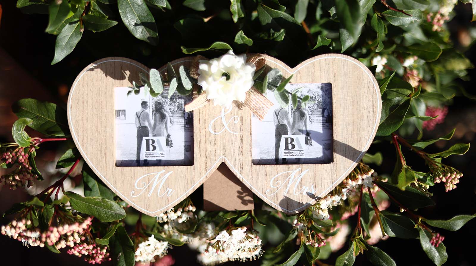 Wooden double photo frame featuring two interlocking hearts, each holding a photo, and adorned with a white flower. A perfect romantic gift for couples, weddings, or anniversaries, symbolizing love and togetherness. 2
